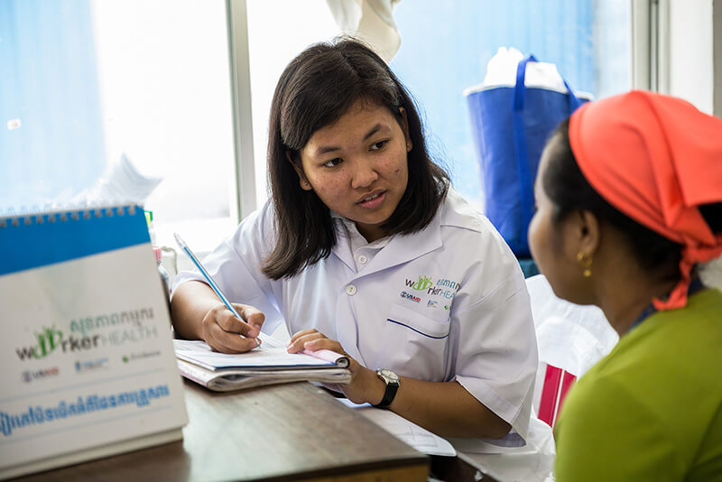 An MSI provider speaks to a client at a factory clinic in Cambodia. The anti-choice opposition sometimes films activity at clinic to intimidate clients and providers.
