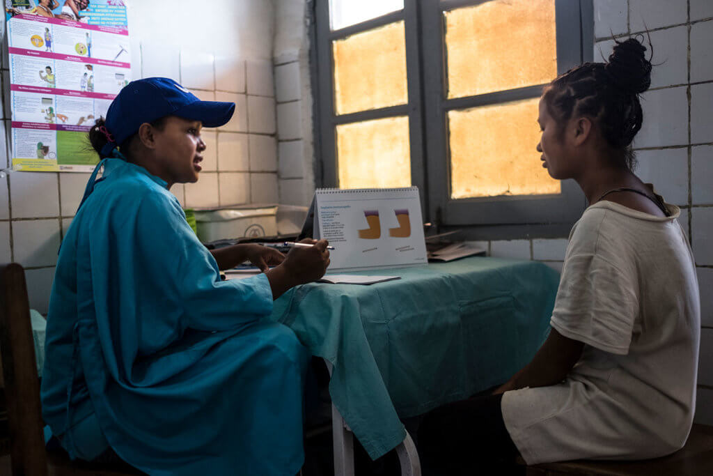 A young woman talks to a nurse at a clinic in Madagascar. Contraception can help girls avoid teen pregnancy and finish school.
