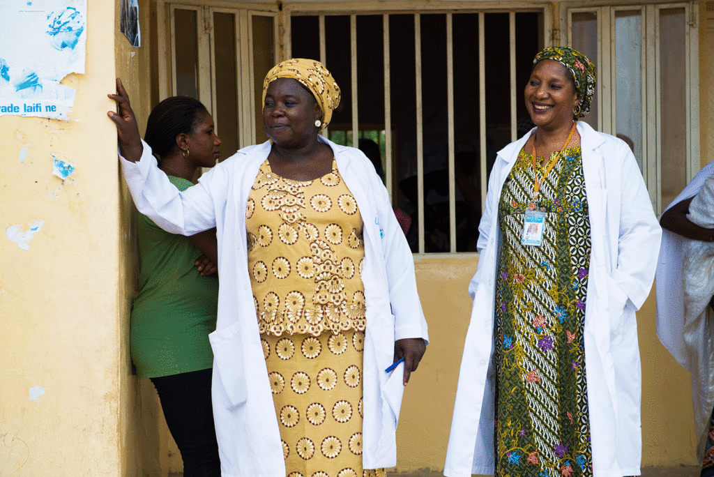 Two MSI providers in white doctor's coats stand outside a clinic in Nigeria.