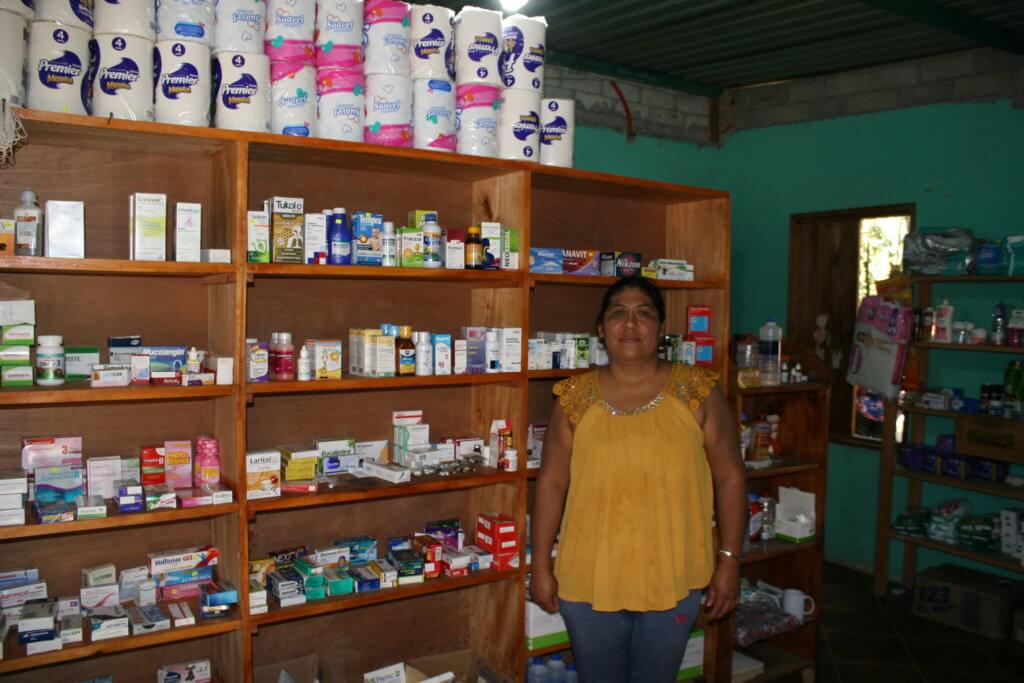 Anastacia, a member of Yadira's network, stands in front of a shelf full of medication.