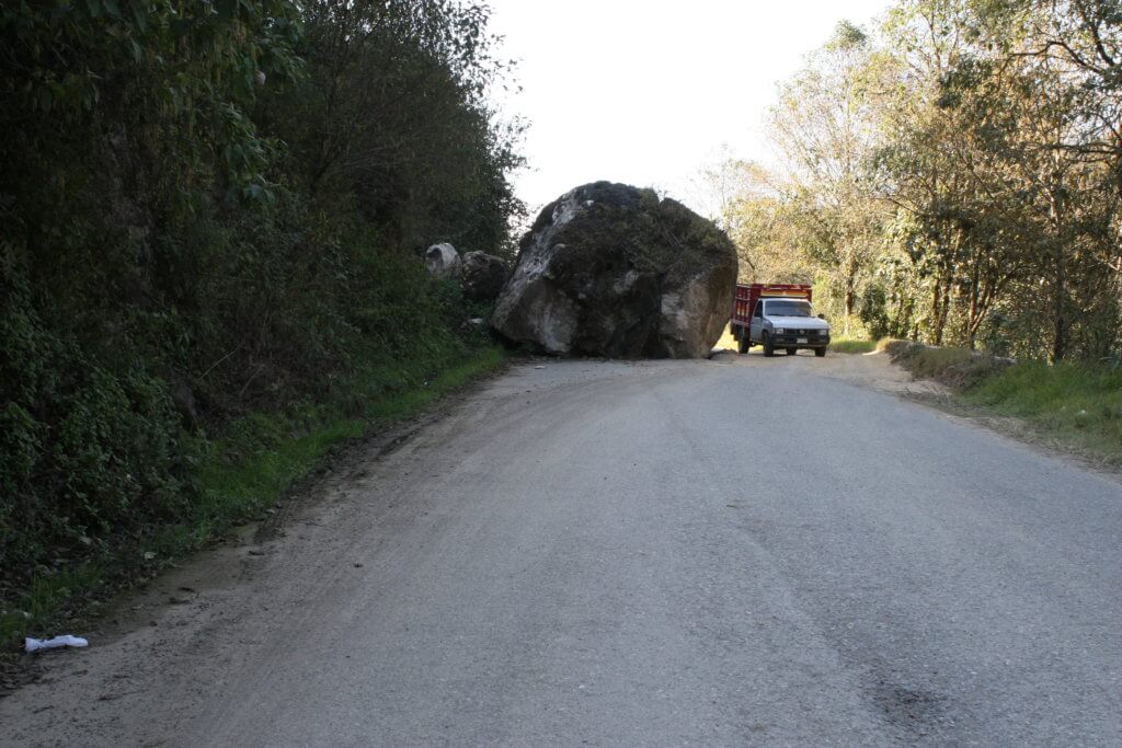 A boulder twice the size of a truck blocks MSI's path on a mountain road in Oaxaca.