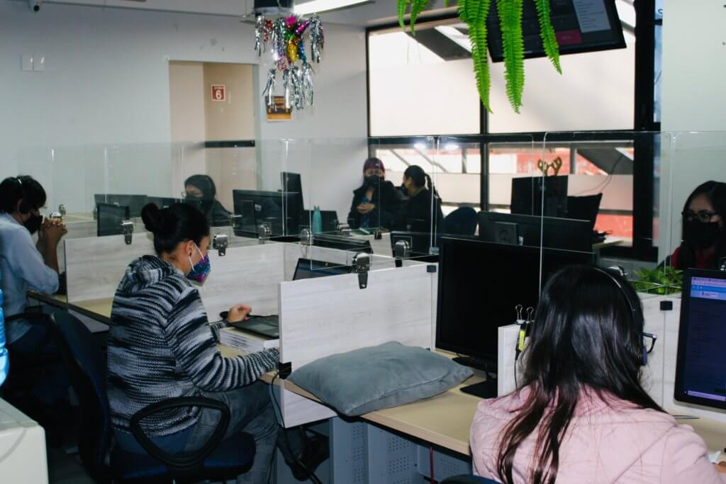 Seven people work on computers at the MSI call center.