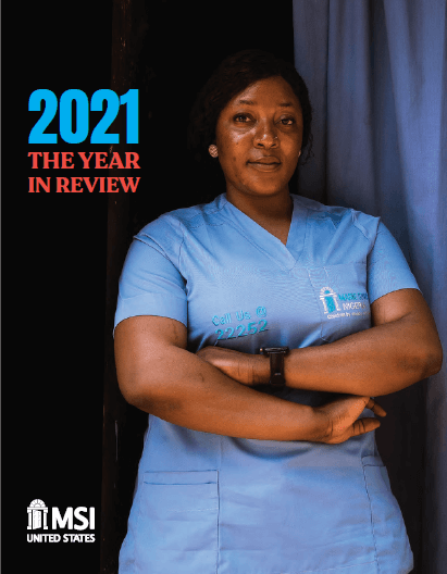 The cover of a report. The title reads "2021: The Year in Review" and the photo is a Nigerian woman in blue scrubs, looking resolutely at the camera.