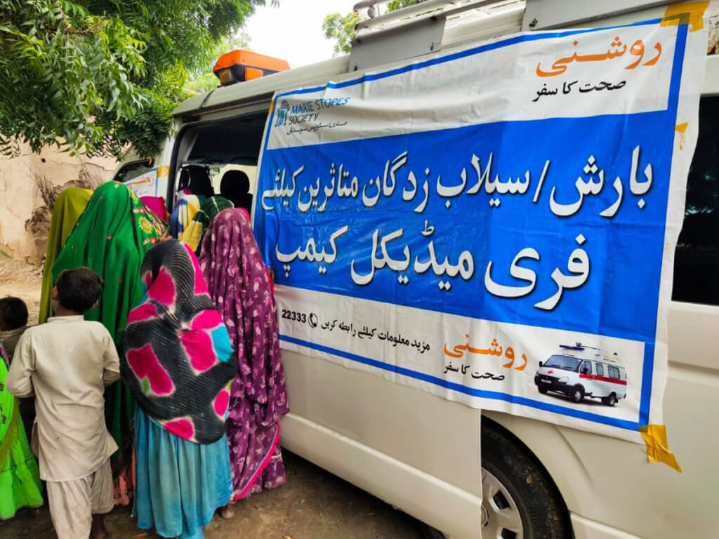A white van with an MSS banner provides flood relief in Pakistan.