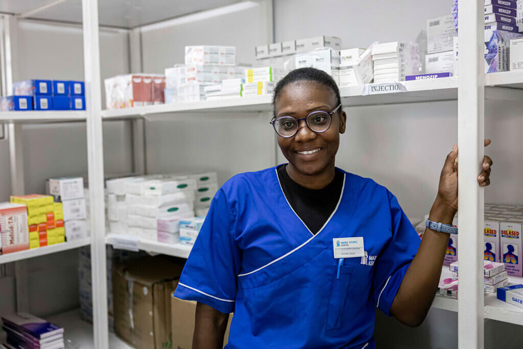 Elizabeth Okoth, a pharmacist in Kenya takes a quick break from checking inventory