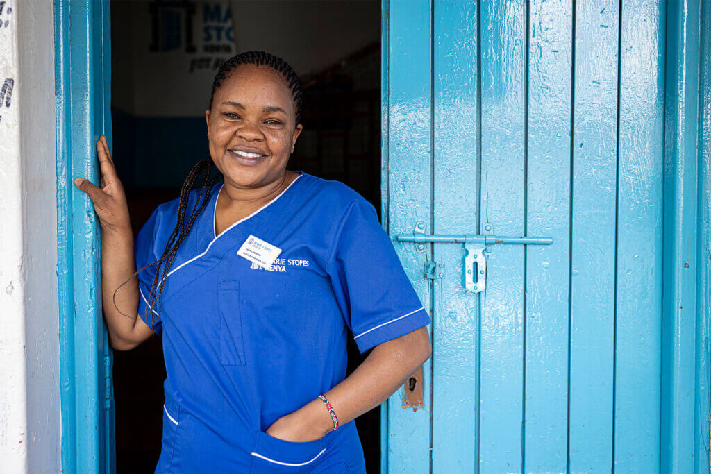 Lilian Omburo, a service provider, pauses in the doorway of the MSI Kangemi clinic in Nairobi, Kenya